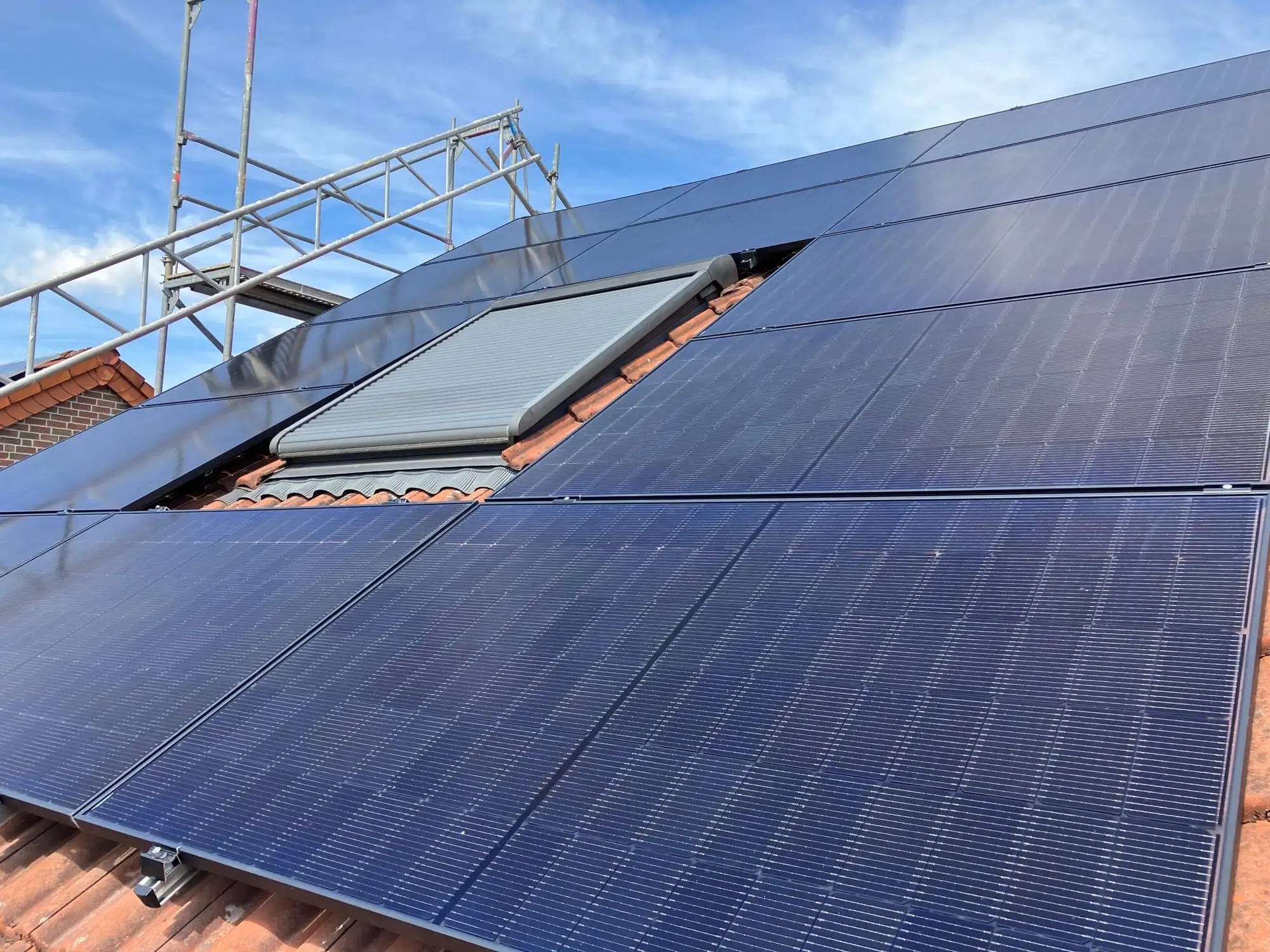 All-Black-PV-Module auf einem Steildach mit roten Ziegeln